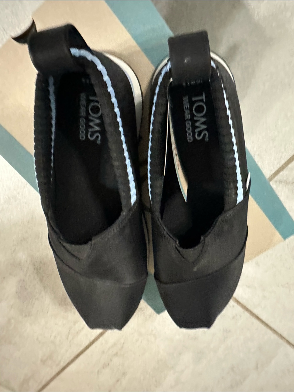 TOMS Black Canvas Slip-Ons with White Trim